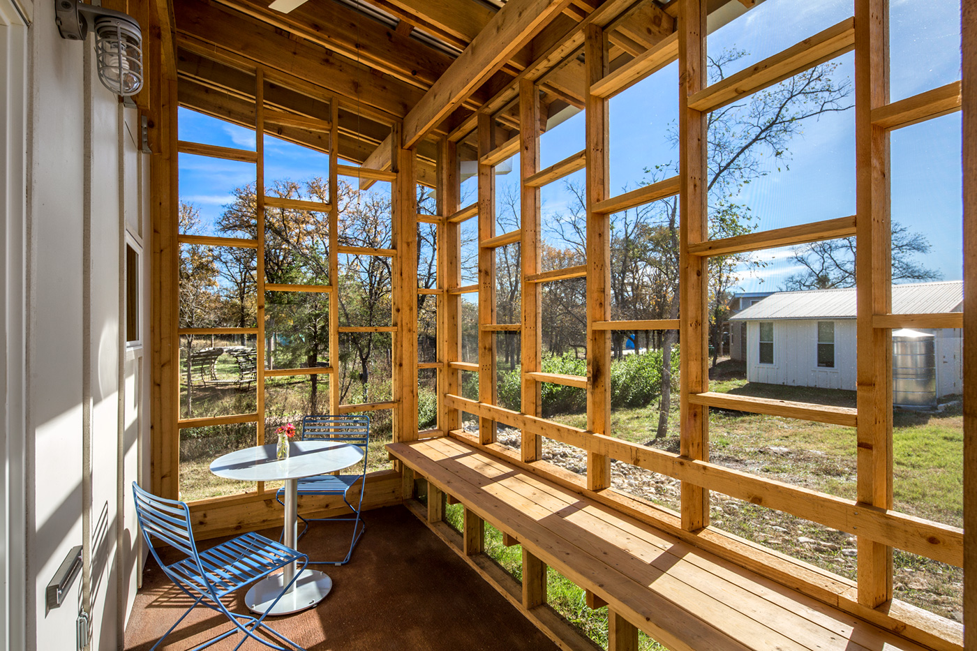 The screened in porch of a micro home.