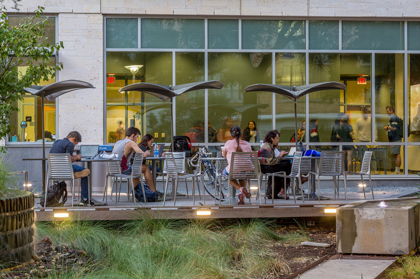 An outdoor deck working area in front of building.