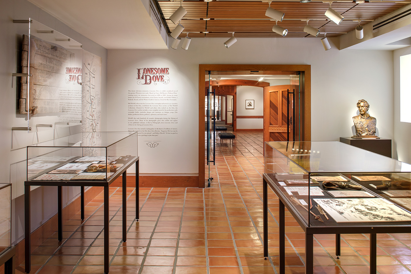 Exhibit room with two glass displays and Writing on the wall that is titles 