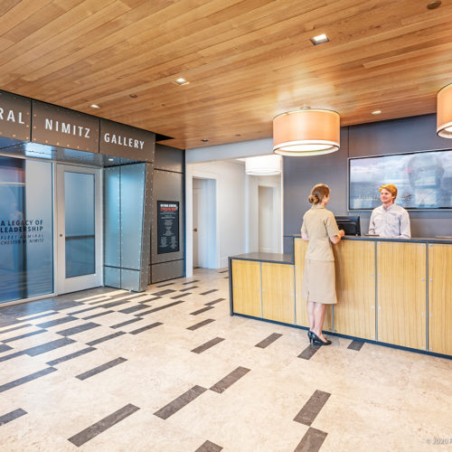 A visitor being helped at a reception desk.