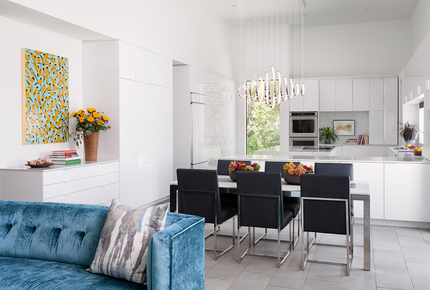 Modern chandelier above dining table.