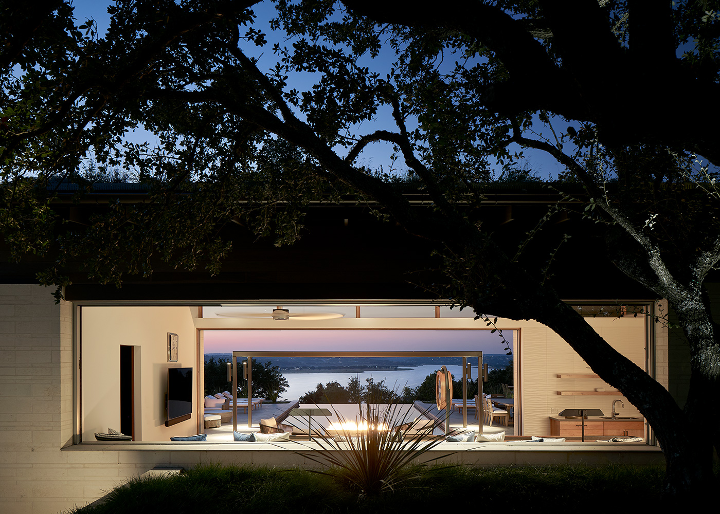 view of a living room and connecting pool to a lake.