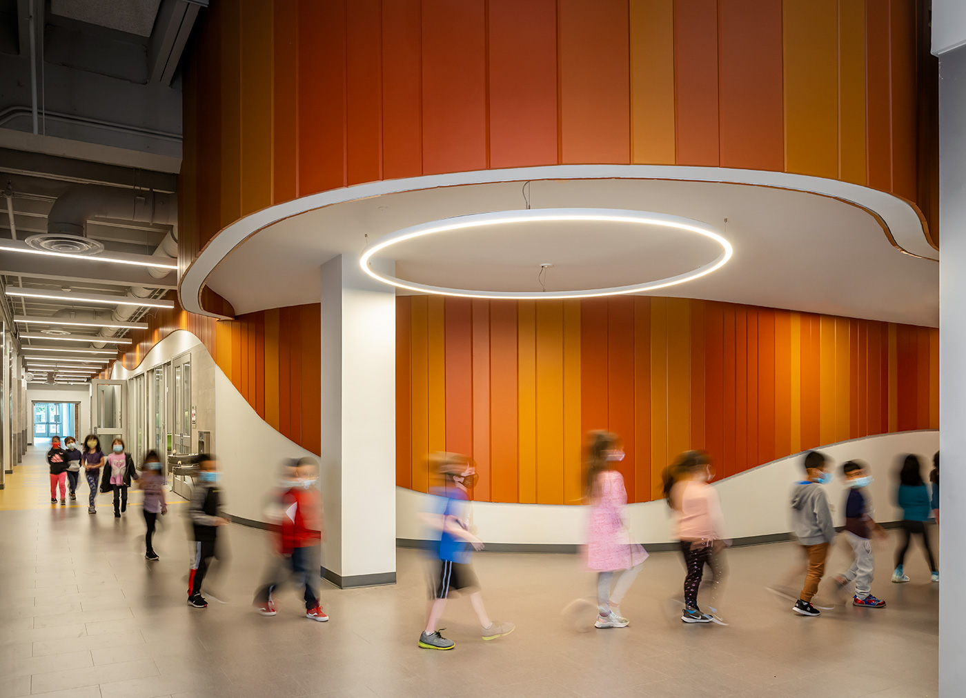 kids walking through hallway in a line.