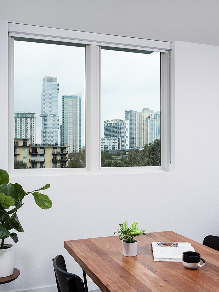 dining table next to window view to a city skyline.