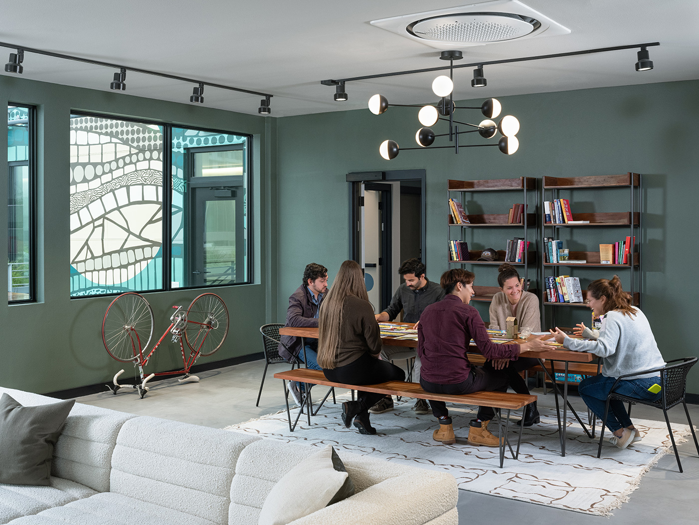 friends dining at large table in modern apartment unit.