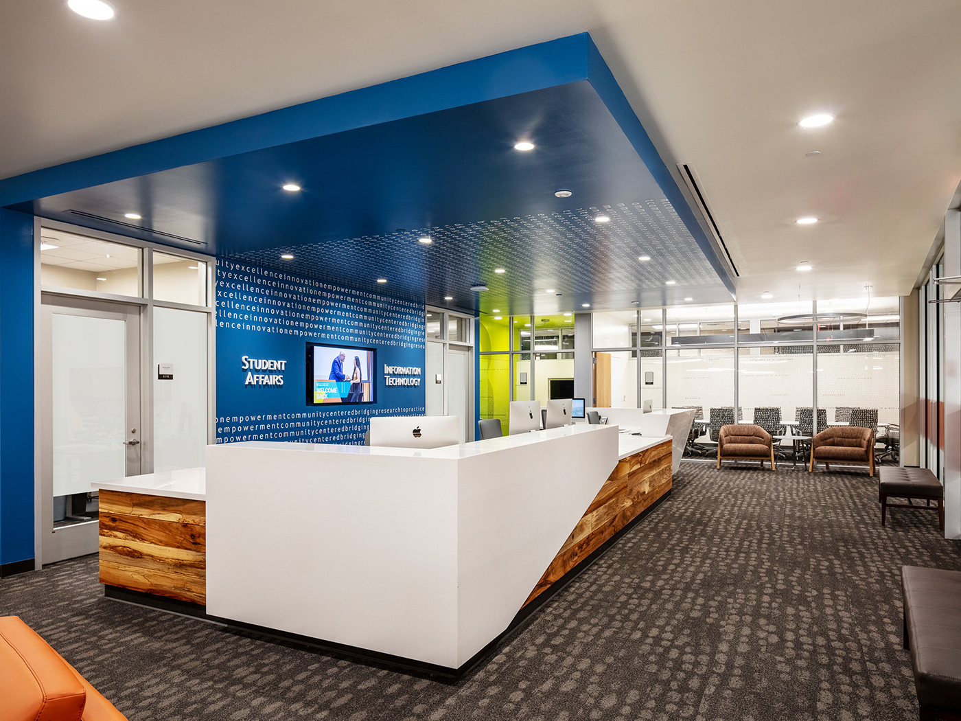 A reception desk in a small lobby with the words 