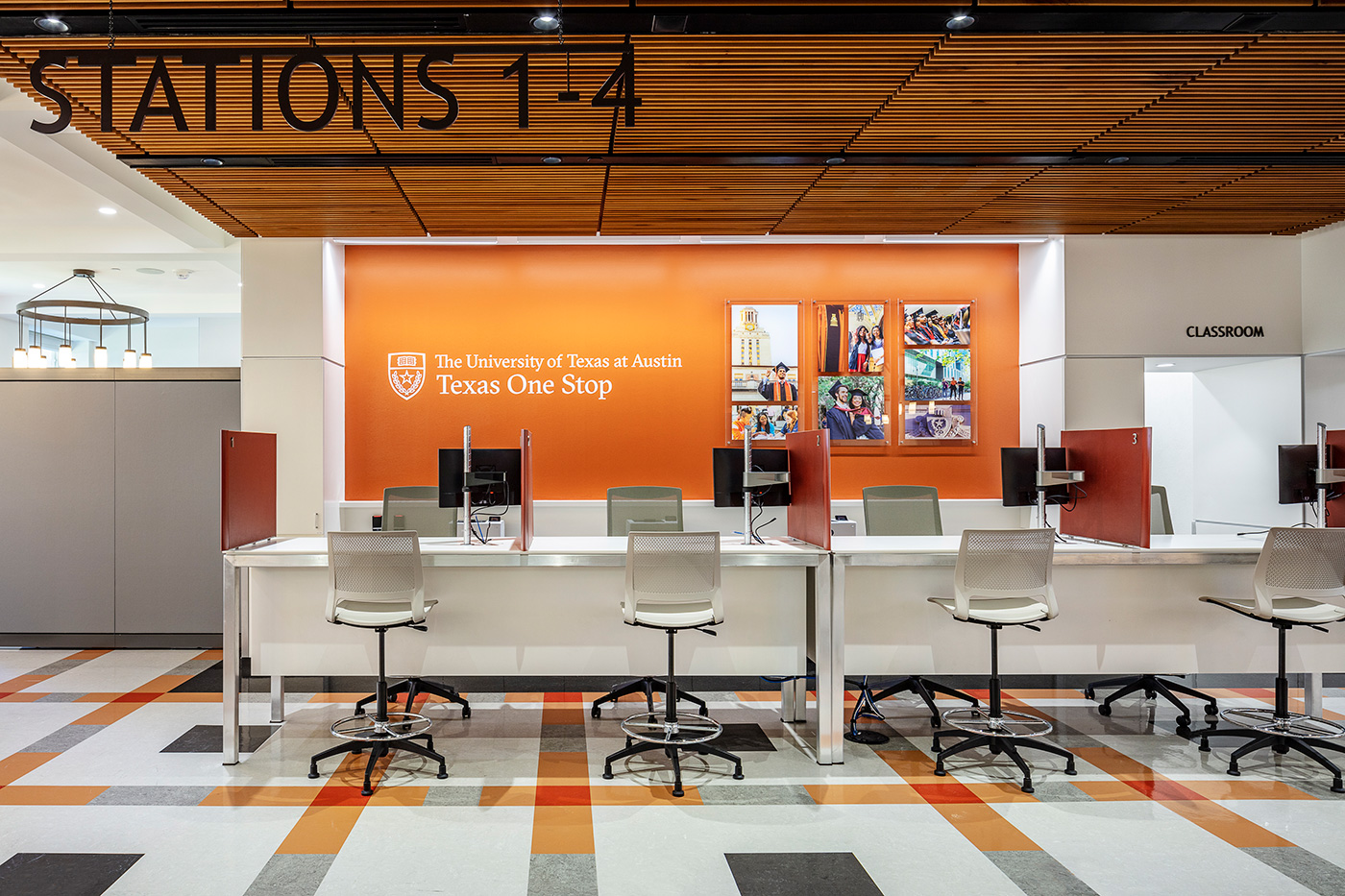 A row of desks in front a wall the reads 