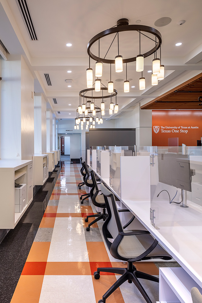 A row of desks in a lounge space.