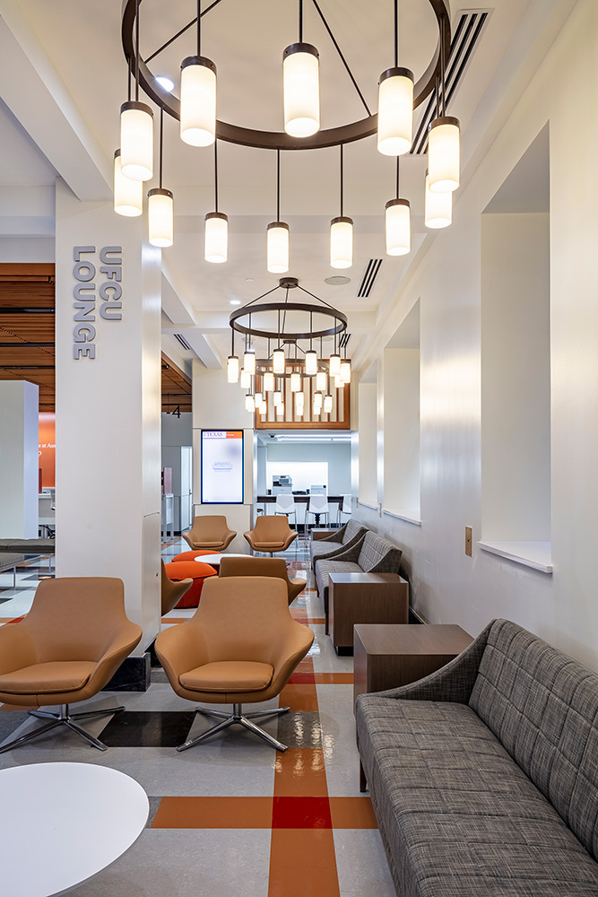 Seating under sleek chandeliers with a Collum reading 