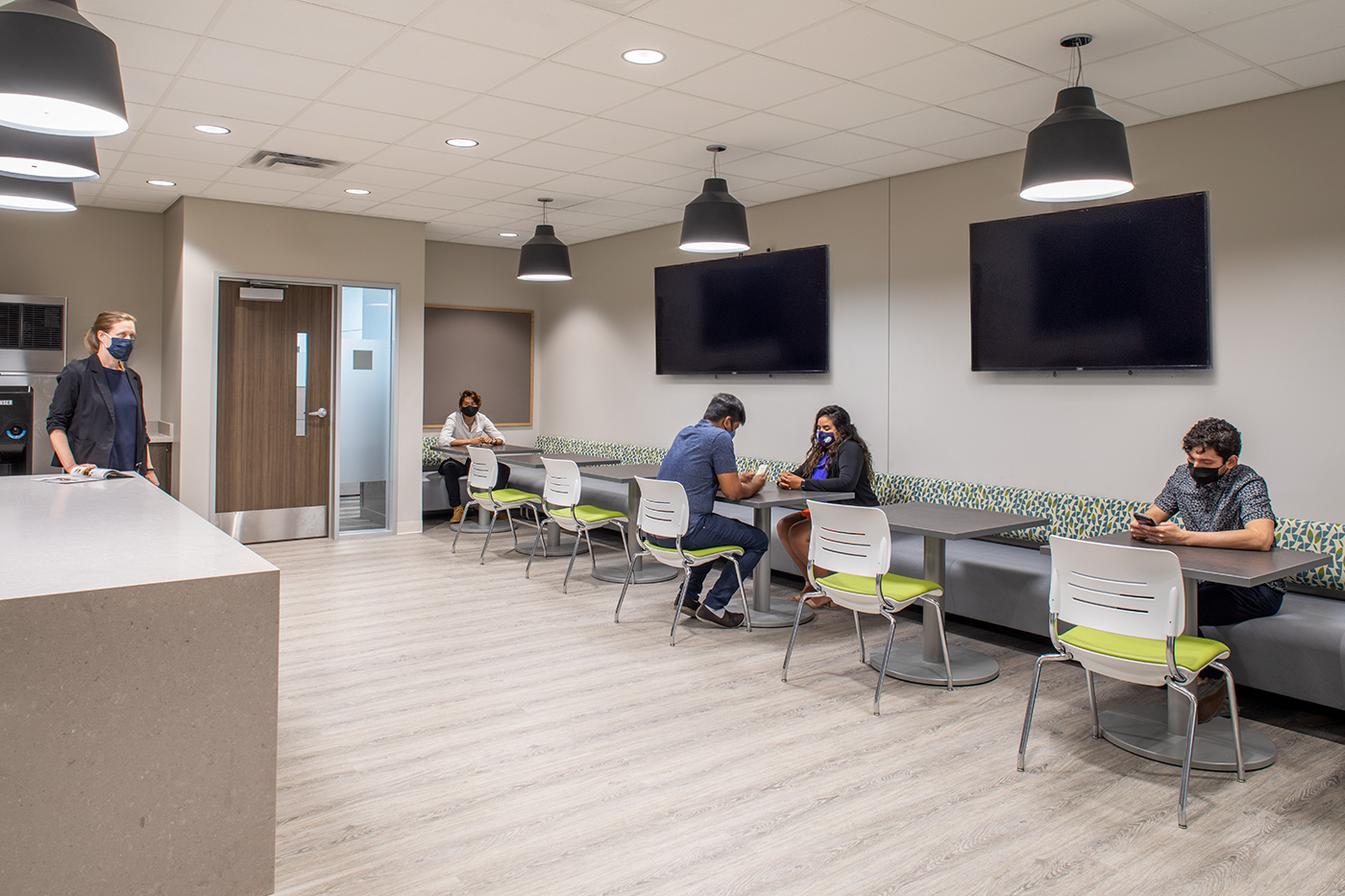 People seated in an office break room.