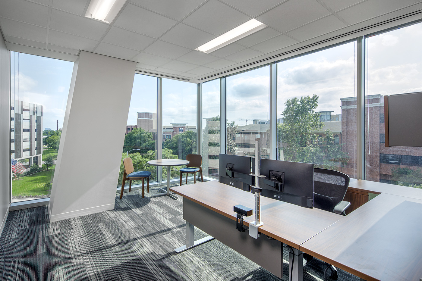 Large corner office with windows.