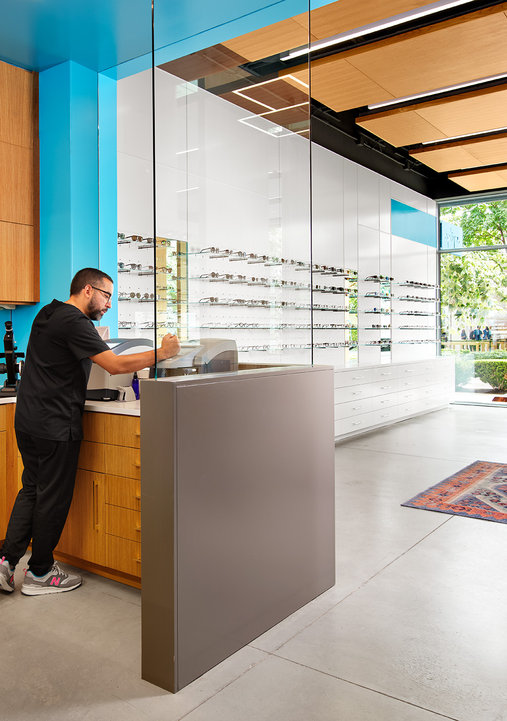 An optometrist working in the back room of a glasses store.