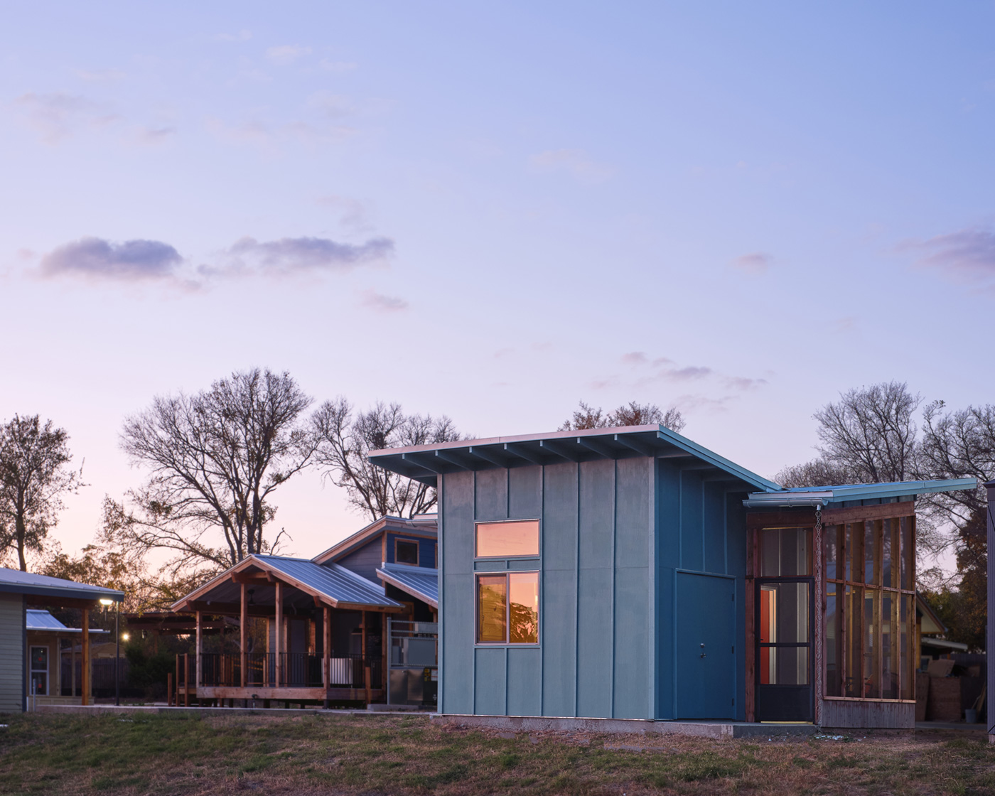The exterior of a tiny home at dusk.