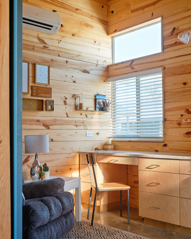 The quaint interior desk of a tiny home.