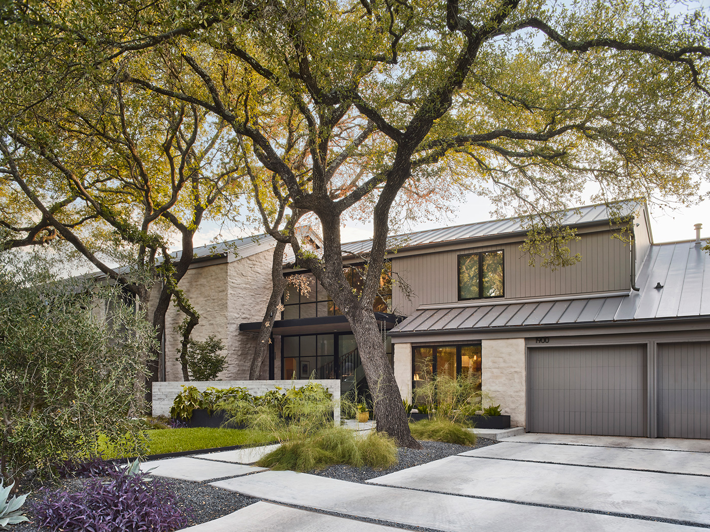 Front entrance, yard and garage doors of a house.