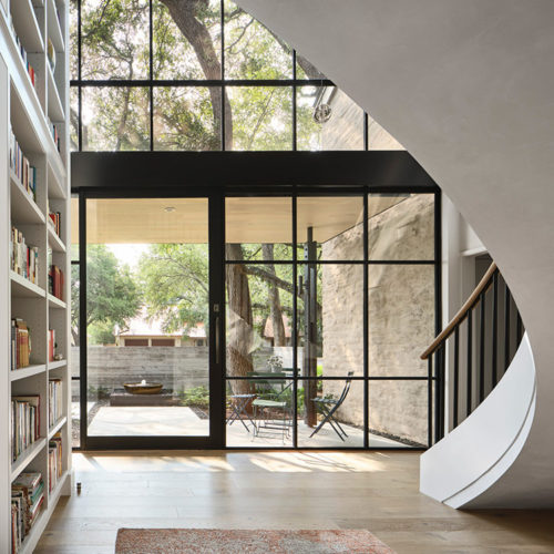 Atrium of a home with winding staircase.