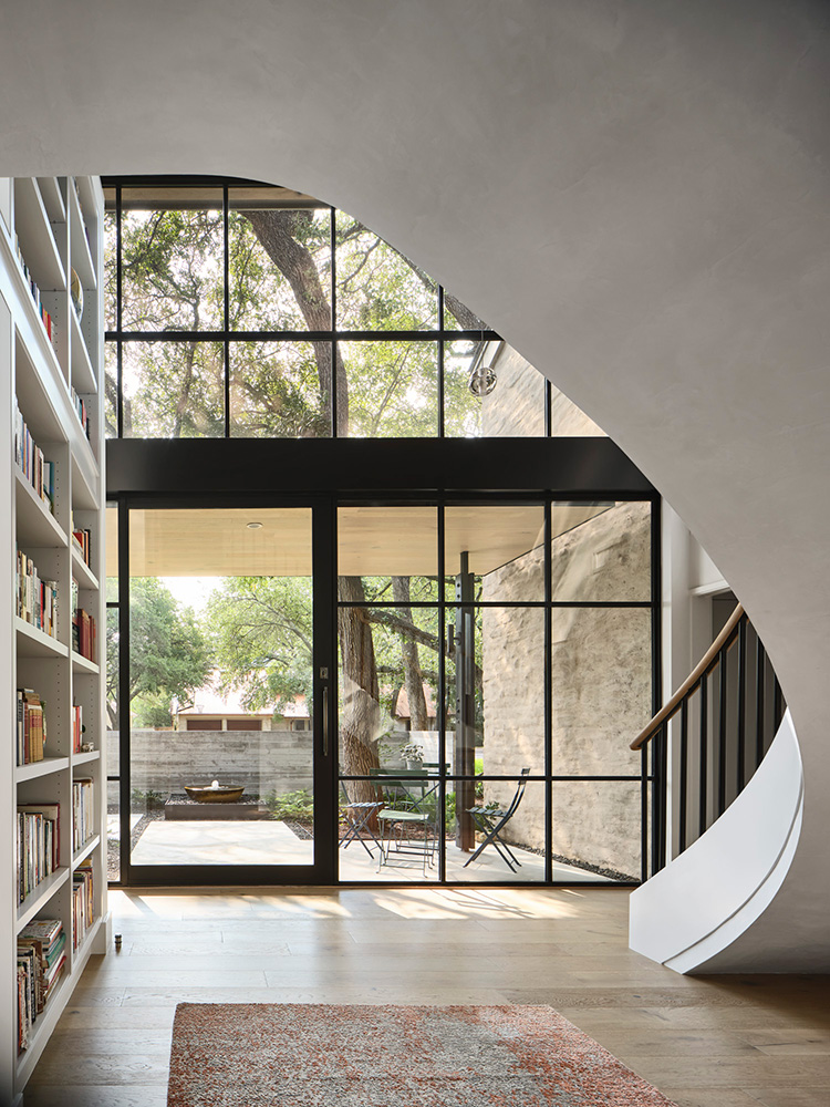 Atrium of a home with winding staircase.