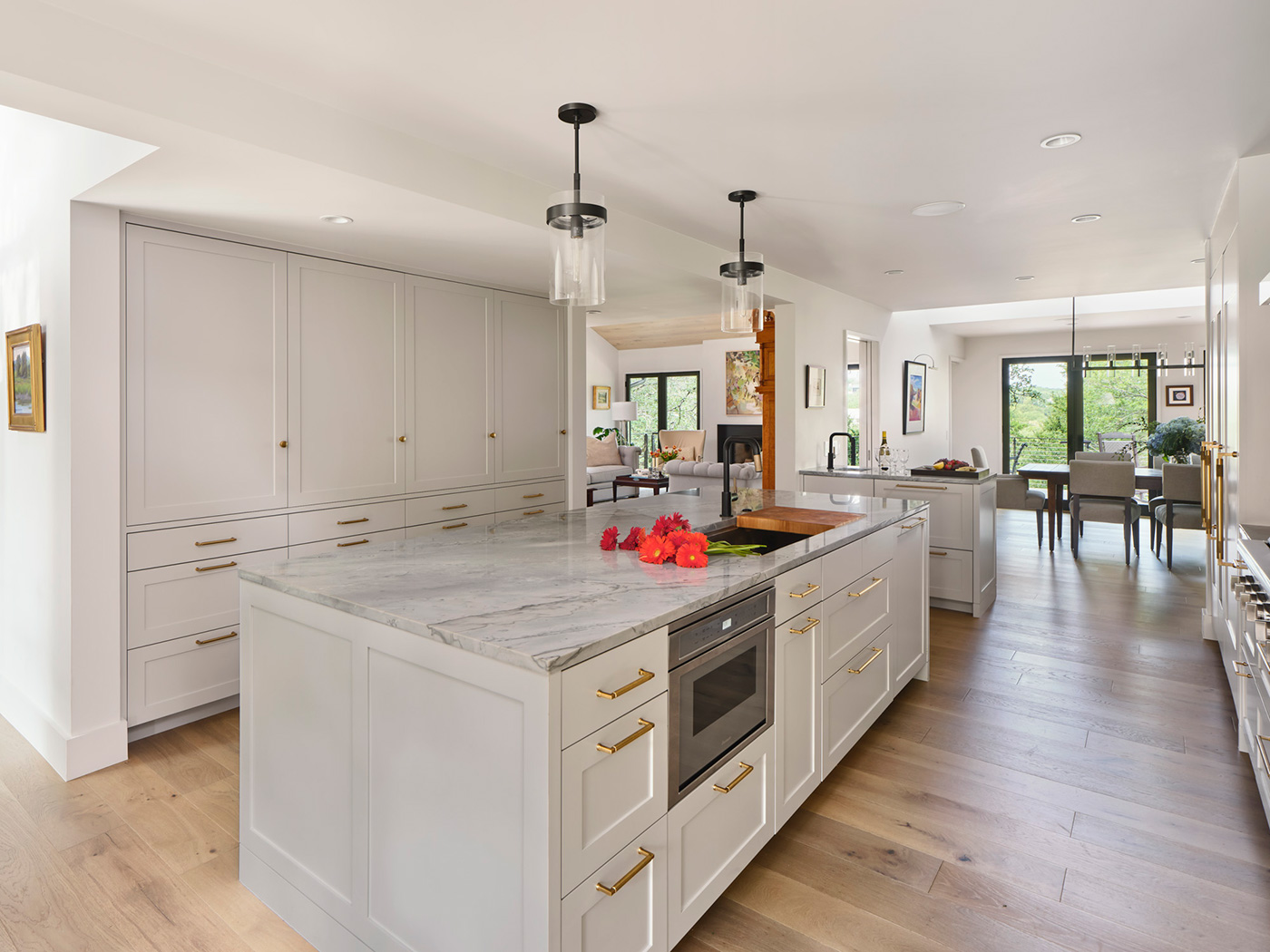 White kitchen with marble countertop.