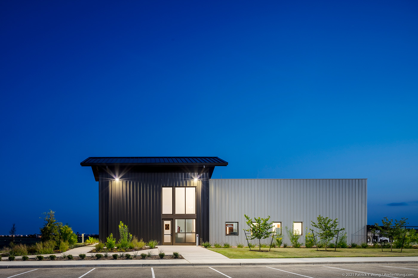 Front face of a metal building from its parking lot.