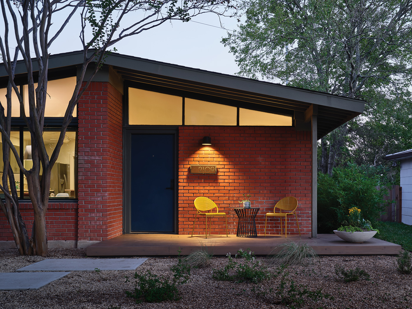 A brick front entrance to a one-story house.