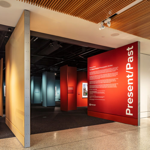 large art exhibit entrance doors with one that reads "Present/Past" in a large white text.