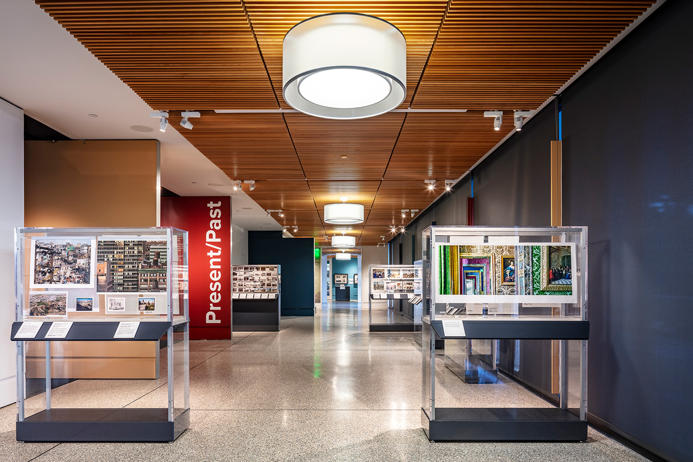 Hallway with four glass display cases containing historic photographs.