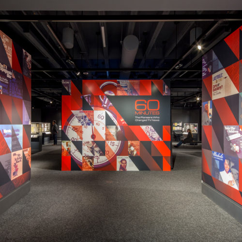 a exhibit entrance comprised of three walls with center place once reading "60 MINUTES The Pioneers Who Changed Tv News".