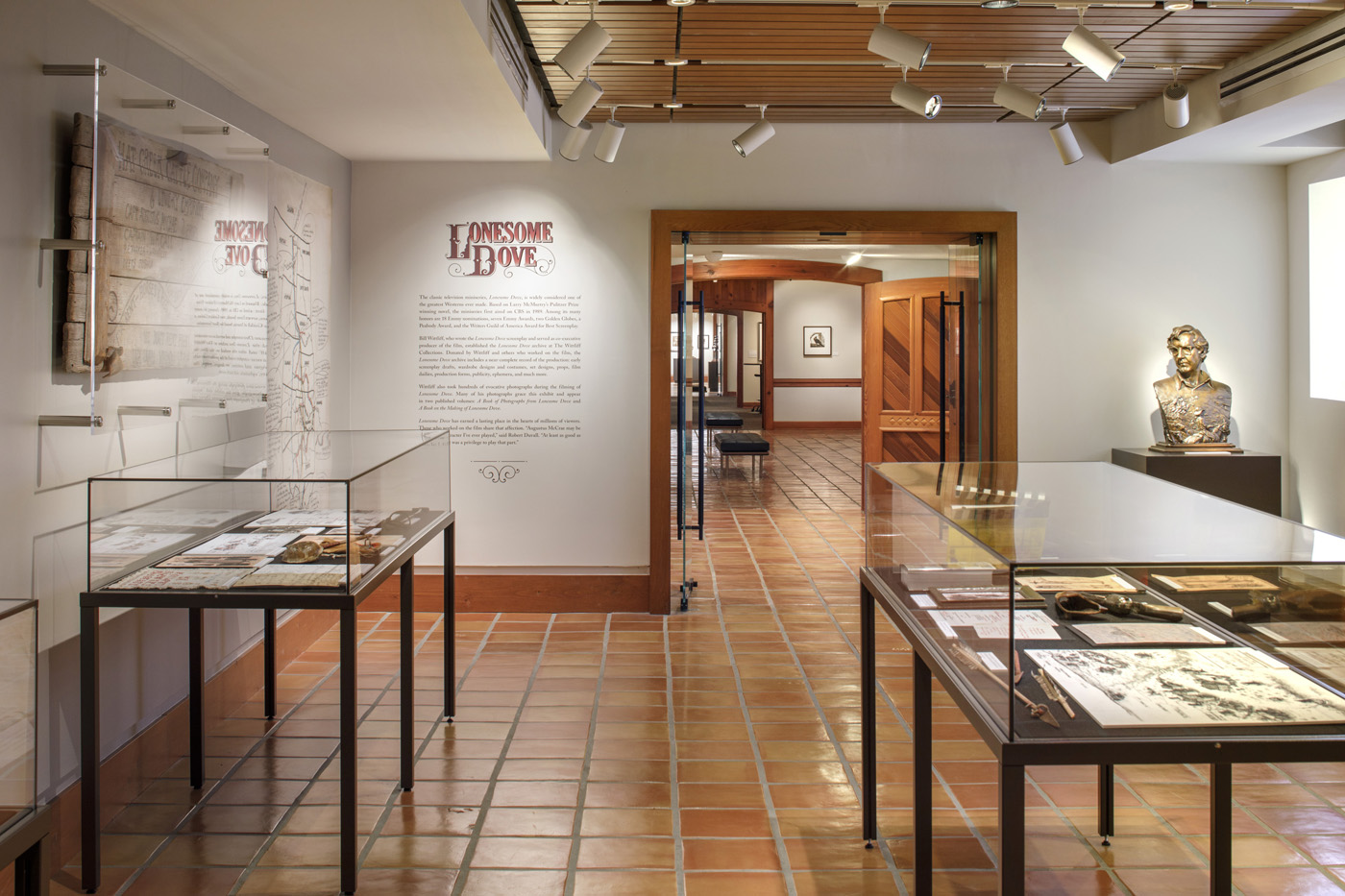 Exhibit room with two glass displays and Writing on the wall that is titles 