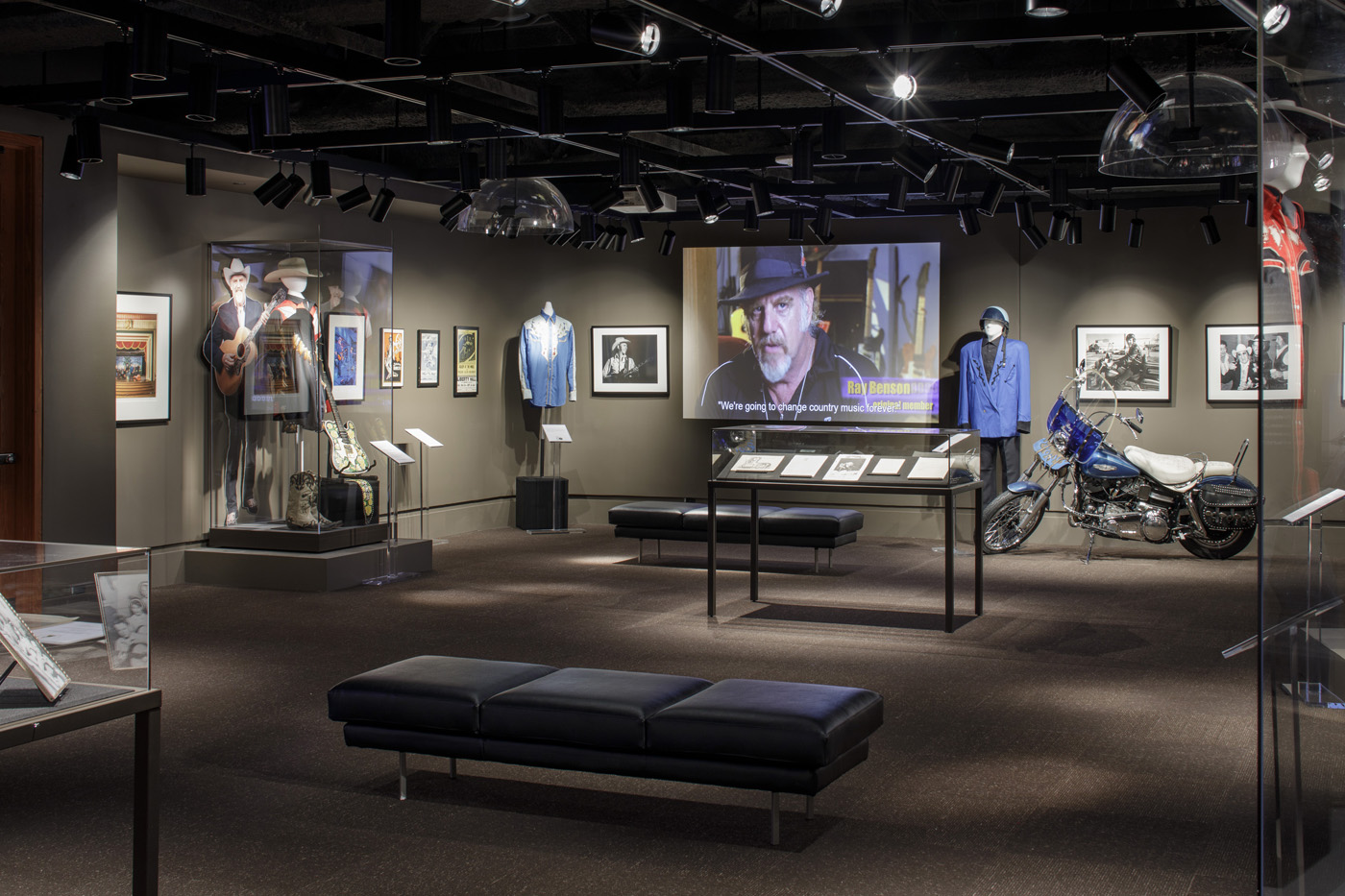 Museum exhibit room with Americana artifacts on display.