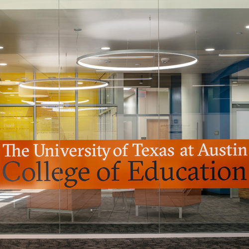 glass wall with large text across the reads "the university of Texas at Austin College of education".