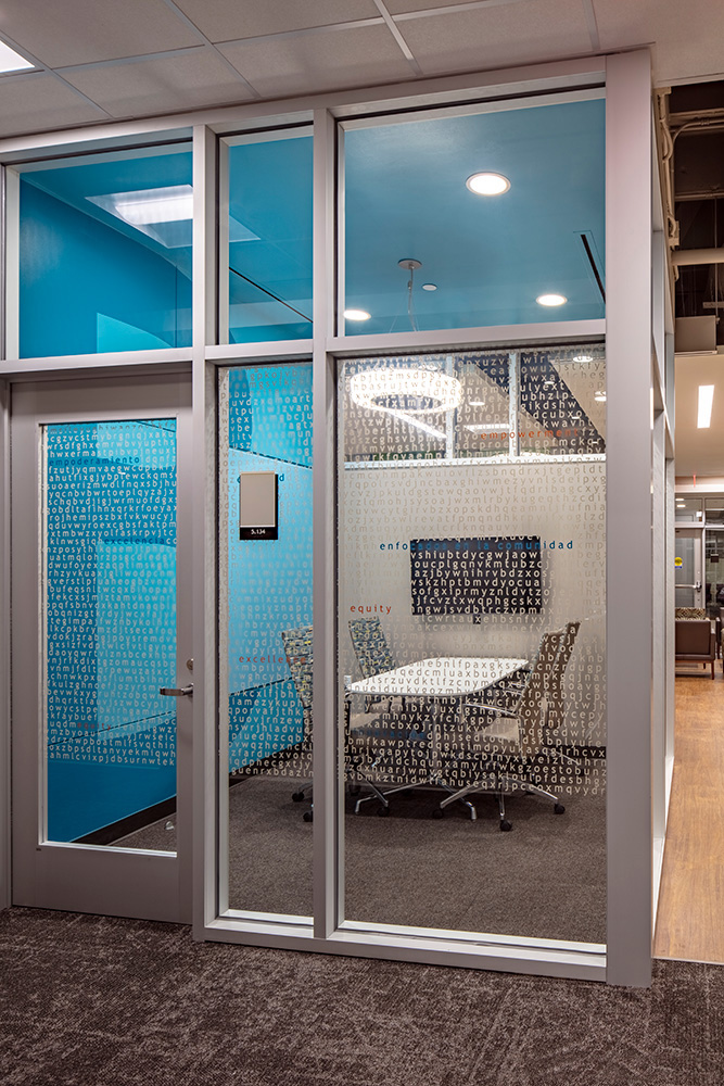Small meeting room enclosed in glass walls.