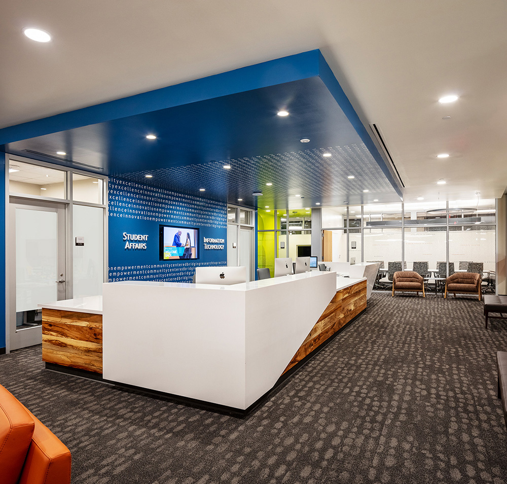 A reception desk in a small lobby with the words 