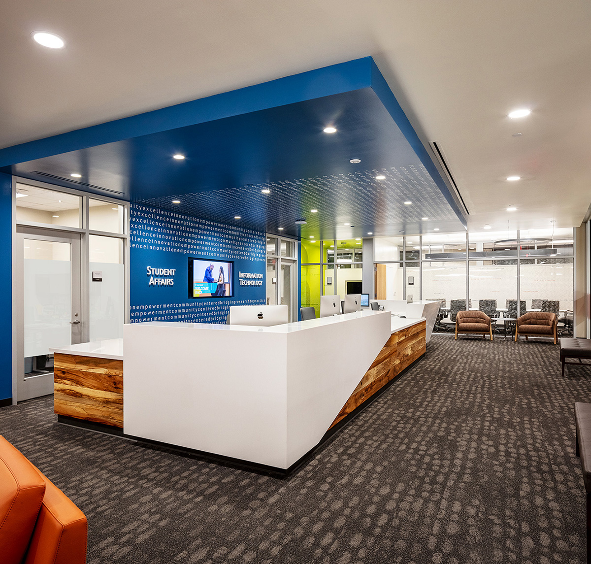 A reception desk in a small lobby with the words 