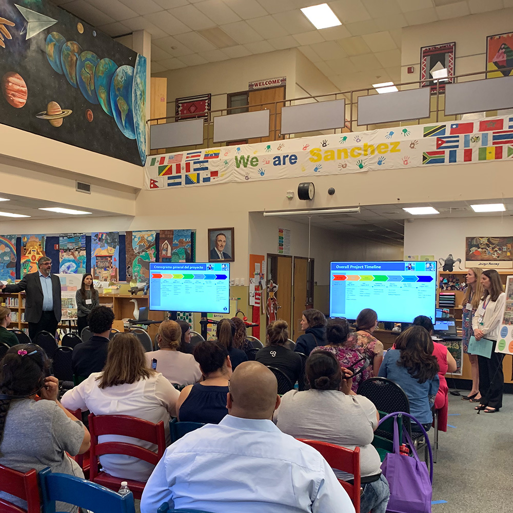 Group giving presentation in an elementary school library.