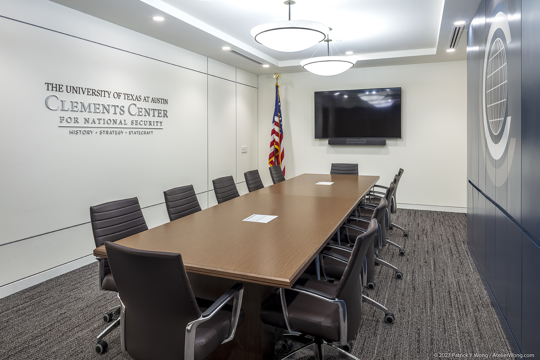 Conference room with leather desks and large wooden table.