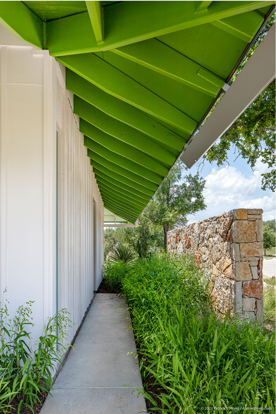 Concrete path underneath a brightly colored roof.