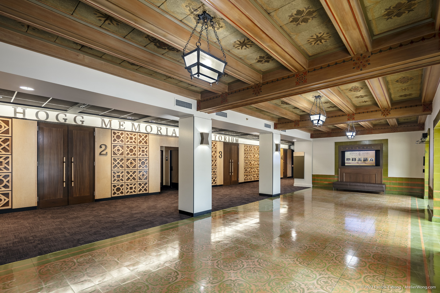 Lobby view showing restored tile floor and wood ceiling beams.